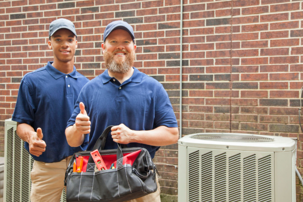 HVAC technicians posing near an outdoor unit