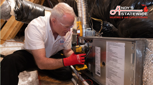 A worker from Andy's provides service on a HVAC unit
