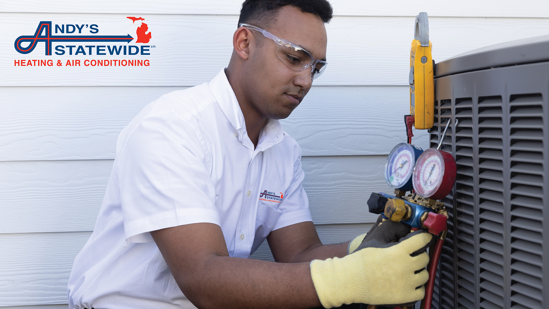 Andys Statewide technician providing home air conditioning service in Detroit MI on outdoor unit.